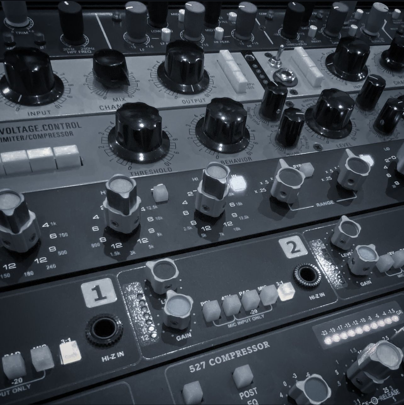 Close-up of outboard compressors and preamps in the Manny Source Productions studio rack